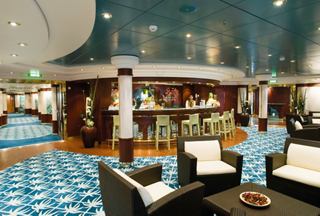 A welcoming spa and relaxation area featuring a bar and comfortable seating, ideal for unwinding on MSC Musica | MSC Cruises