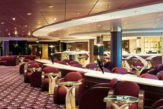A welcoming lounge area featuring comfortable seating and a bar counter, ideal for relaxation and socialising | MSC Cruises