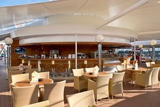 A stylish bar area on MSC Musica with comfortable seating and patrons enjoying the ambiance | MSC Cruises