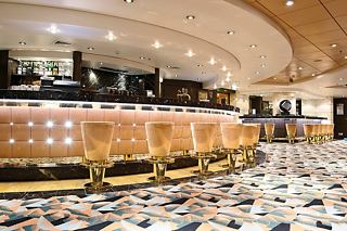 A warm and inviting bar area on MSC Musica featuring elegant design and comfortable seating | MSC Cruises