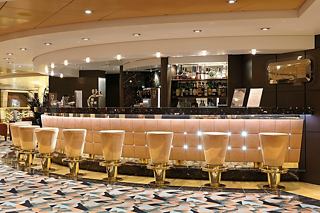 A warm and inviting bar setting with stylish seating and a sleek counter on MSC Musica | MSC Cruises