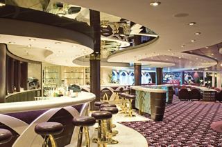 A stylish bar area in Il Tucano Lounge on MSC Musica with comfortable seating and a welcoming atmosphere | MSC Cruises
