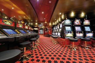 A vibrant casino interior on the MSC Poesia featuring slot machines and inviting décor | MSC Cruises