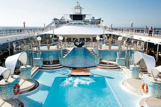 A vibrant pool area on the deck of MSC Poesia, featuring sun loungers and a large screen for entertainment | MSC Cruises