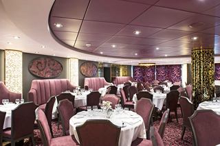 Eleganter Essbereich im Restaurant L'Arabesque mit für Gäste arrangierten Tischen und Stühlen | MSC Cruises