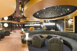 A stylish lounge area with comfortable seating, inviting guests to relax and enjoy the atmosphere | MSC Cruises