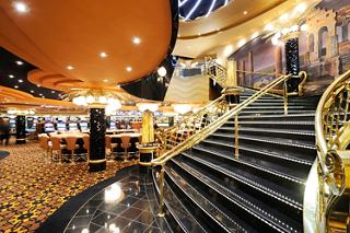 A vibrant casino area aboard MSC Preziosa, featuring elegant stairs and inviting seating spaces for entertainment | MSC Cruises