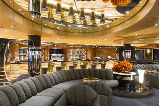 A stylish bar area with elegant seating and warm lighting invites relaxation aboard MSC Preziosa | MSC Cruises