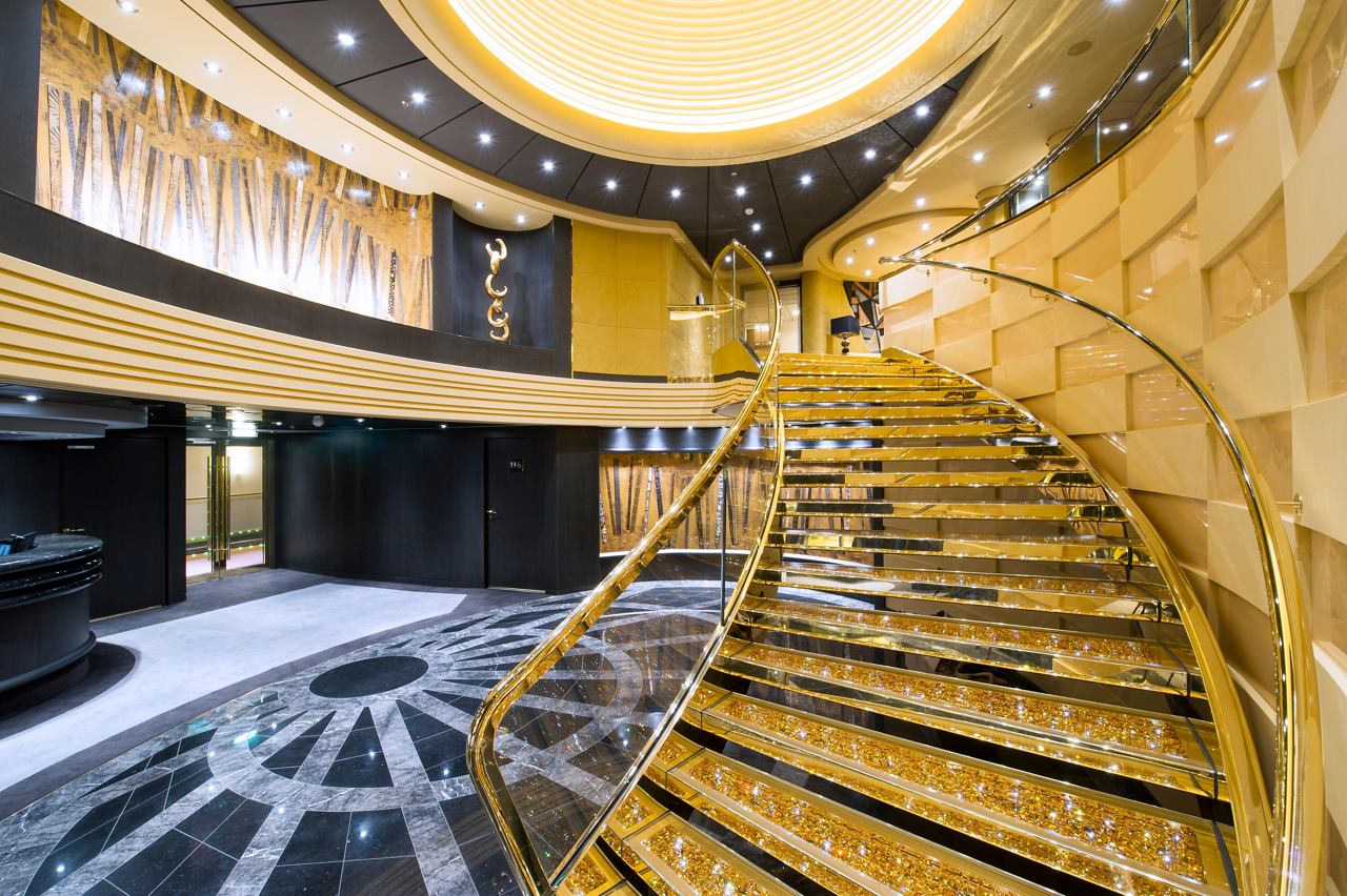 Elegant spiral staircase in the MSC Yacht Club, showcasing luxurious design and inviting atmosphere | MSC Cruises