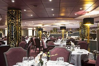 Elegant dining setup in L'Arabesque Restaurant aboard MSC Preziosa, featuring tables, chairs, and decorative elements | MSC Cruises