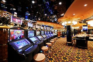 A vibrant casino area featuring slot machines and gaming tables on the MSC Preziosa | MSC Cruises