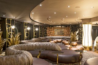 A serene lounge area featuring comfortable sofas, tables, plants, and elegant decor for relaxation aboard MSC Preziosa | MSC Cruises