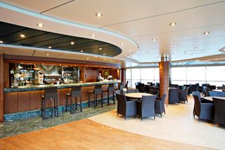 Modern bar featuring cozy seating areas and service from the crew | MSC Cruises