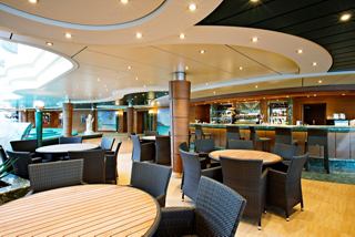 Modern seating area with tables and chairs, perfect for socializing onboard | MSC Cruises