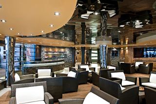 Modern and cozy spa area featuring tables and chairs for relaxation | MSC Cruises