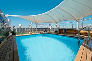 The inviting outdoor pool area of the MSC Yacht Club on MSC Splendida, perfect for relaxation and enjoyment | MSC Cruises