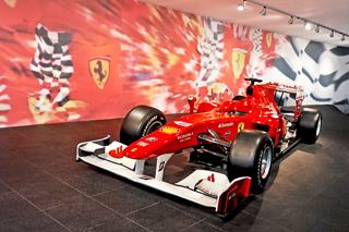 A Ferrari race car displayed in a vibrant setting at Ferrari World, Abu Dhabi, inviting thrilling adventures | MSC Cruises