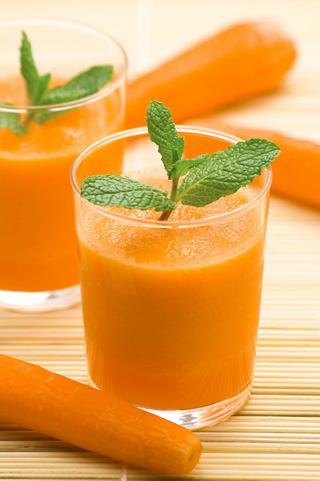 Refreshing carrot juice garnished with mint leaves served in a glass, ideal for enjoying at the MSC Aurea Spa | MSC Cruises