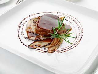 A beautifully presented dish featuring tender meat garnished with radicchio and rosemary, served at Il Giardino Restaurant | MSC Cruises