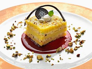A delicious dessert served elegantly on a plate, featuring a vibrant cake with decorative elements | MSC Cruises