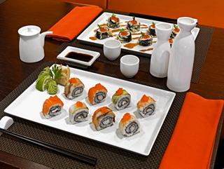 A beautifully arranged sushi platter with rolls, ginger, and wasabi on a table at Kaito Sushi Bar | MSC Cruises
