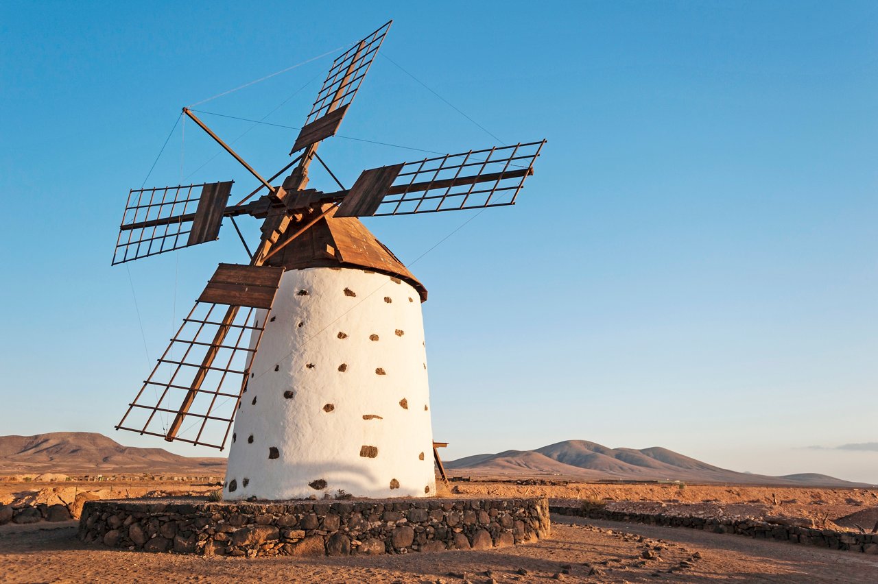 A traditional windmill stands against a clear blue sky in Fuerteventura, Spain, showcasing the beauty of the Canary Islands | MSC Cruises