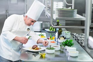 A chef is engaged in food preparation in a cruise restaurant | MSC Cruises