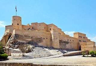 The majestic Nakhl Fort stands proudly against a clear blue sky, symbolising Oman's rich heritage | MSC Cruises