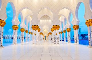 A beautiful, spacious mosque interior with elegant columns and soft blue lighting, inviting exploration and reflection | MSC Cruises