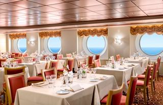 A beautifully arranged dining area in the Marco Polo restaurant featuring elegant tables and views of the sea | MSC Cruises