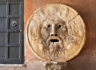Golden lion mask on a wall in Rome symbolizing history and culture | MSC Cruises