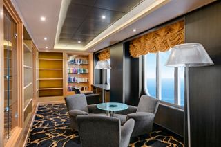 Cozy area with armchairs and a table, perfect for relaxing on MSC Armonia | MSC Cruises