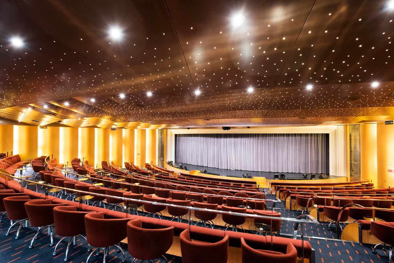 The elegant interior of the Teatro La Fenice theatre aboard MSC Armonia, showcasing rows of seating and a stage | MSC Cruises