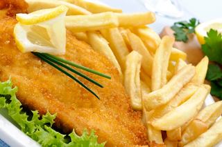 Crispy breaded fish with golden chips, fresh salad, and a slice of lemon for a delightful dining experience | MSC Cruises