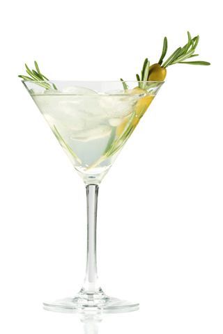 A refreshing cocktail served in a martini glass, garnished with olive and rosemary | MSC Cruises