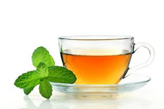 A cup of refreshing tea accompanied by a mint leaf, inviting relaxation and enjoyment | MSC Cruises