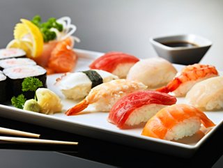 A beautifully arranged platter of sushi and sashimi with fresh garnishes and dipping sauces | MSC Cruises