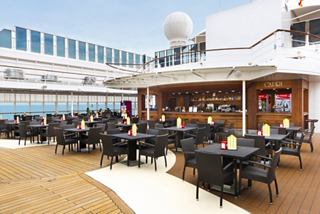 Restaurant accueillant sur le pont avec des tables et des chaises | MSC Croisières