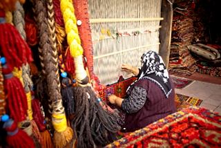 A woman weaves intricate patterns on a loom, showcasing traditional carpet craftsmanship in Turkey | MSC Cruises