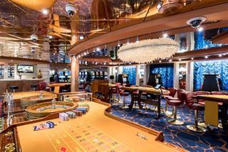 Une zone de casino dynamique sur le MSC Sinfonia avec des tables de jeu et un bar pour une expérience excitante | MSC Croisières