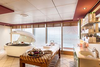 A serene spa treatment room with large windows and soothing decor, inviting relaxation and wellness | MSC Cruises
