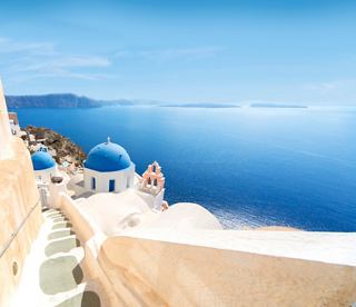 A scenic view of Santorini's iconic architecture against the backdrop of the deep blue sea | MSC Cruises