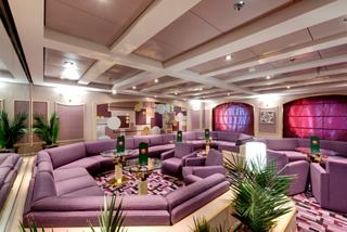A welcoming bar area on MSC Opera featuring stylish seating and a warm atmosphere for relaxation | MSC Cruises