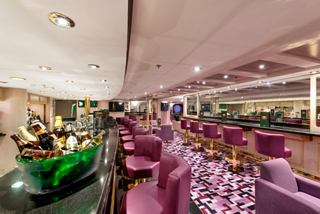 A welcoming bar area with comfortable seating and a vibrant atmosphere for socialising on MSC Opera | MSC Cruises