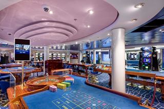 A vibrant casino area on MSC Opera featuring gaming tables and machines for an exciting entertainment experience | MSC Cruises
