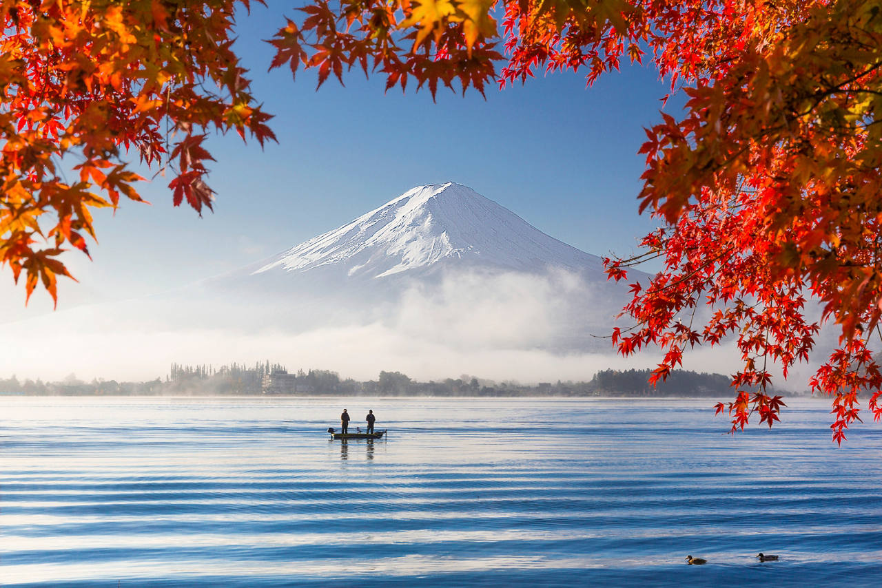 Autumn leaves frame a serene view of Lake Kawaguchigo with Mount Fuji in the background | MSC Cruises