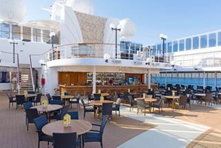 A welcoming outdoor bar area with tables and chairs, perfect for socialising and enjoying drinks on the deck | MSC Cruises