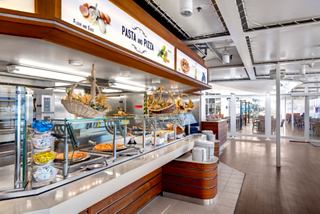 A vibrant restaurant area featuring a selection of pasta and pizza on display | MSC Cruises