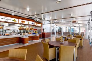 A spacious dining area with wooden furniture and a welcoming atmosphere for enjoying pasta and pizza | MSC Cruises