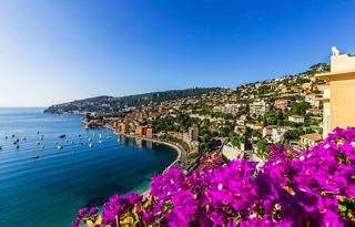 A vibrant view of Villefranche's coastline adorned with colourful flowers, showcasing the beauty of the French Riviera | MSC Cruises
